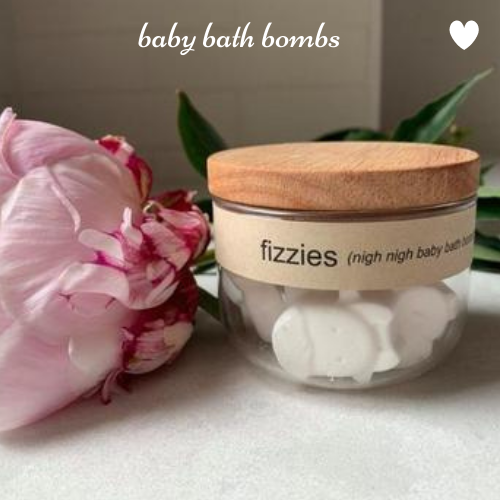 125g bamboo and glass reusable jar containing "Fizzies" essential oil animal shaped baby bath bombs for bedtime.